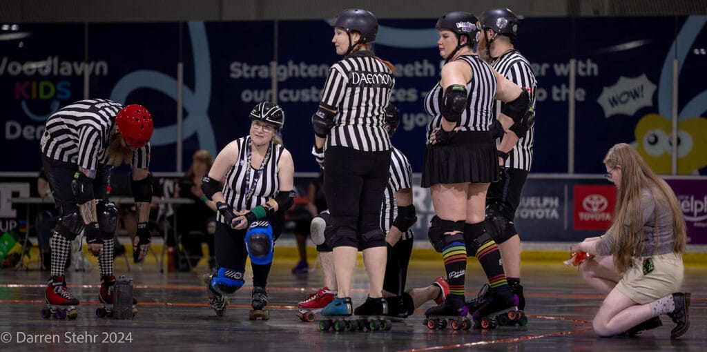Photo of refs conferring.